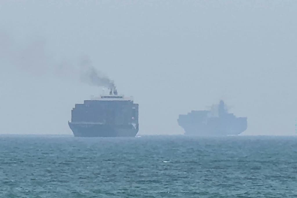 Cargo ships anchor off the eastern coast of the United Arab Emirates at Khor Fakkan