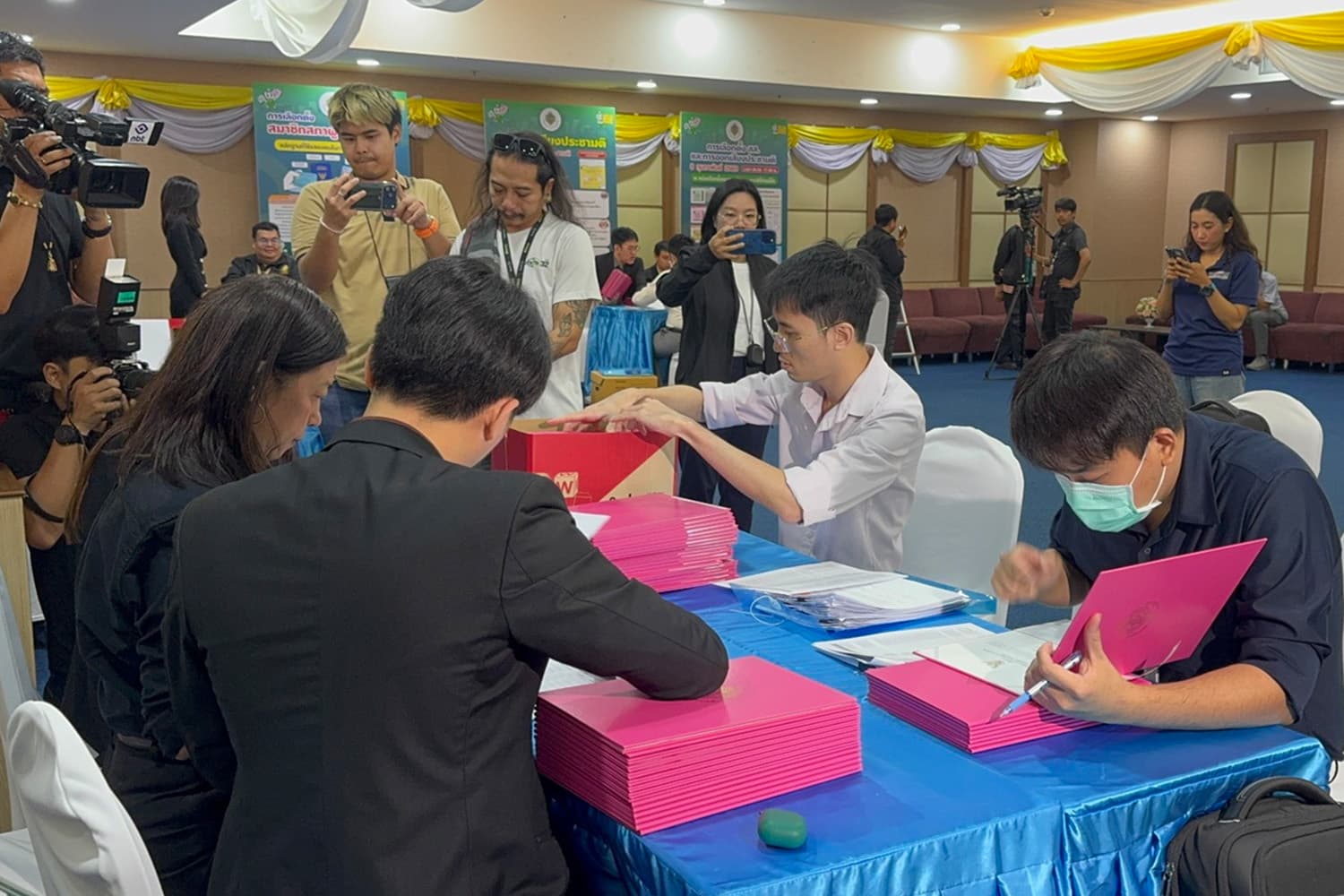 ‘ผู้แทนพรรคส้ม’ แบกลังใส่หนังสือรับรอง สส. ก่อนไปรายงานตัวต่อที่สภาฯ