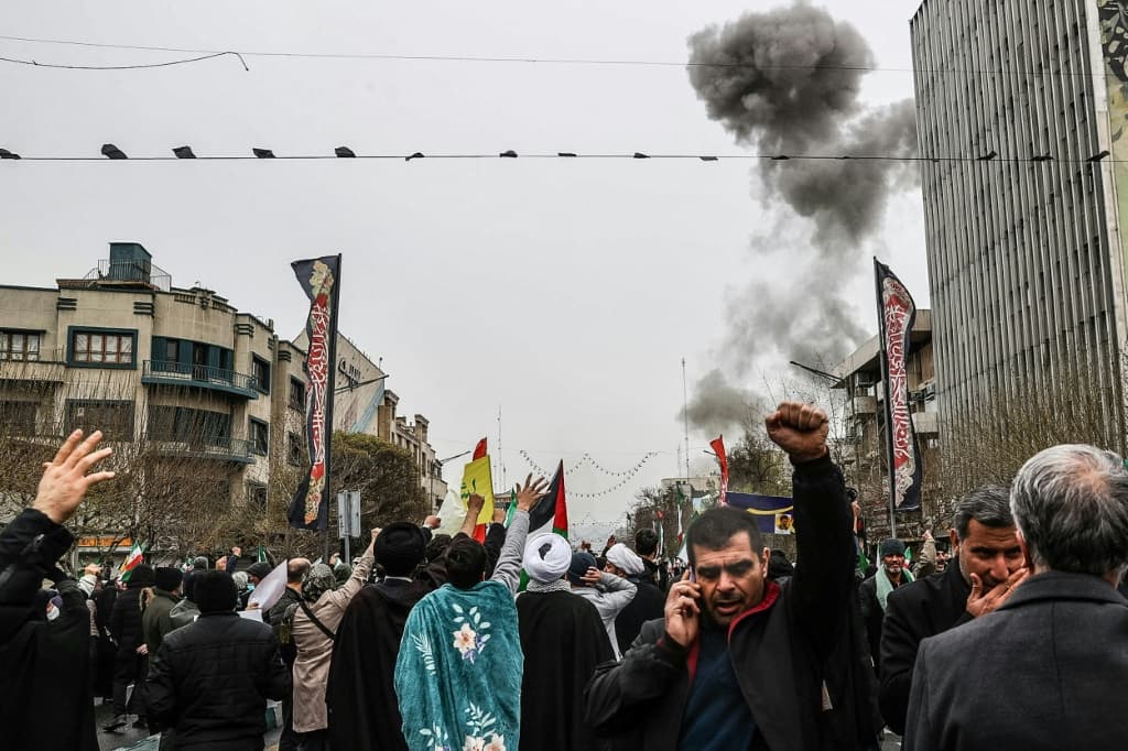 Iranian officials attended a pro-government rally in Tehran as explosions rocked the city