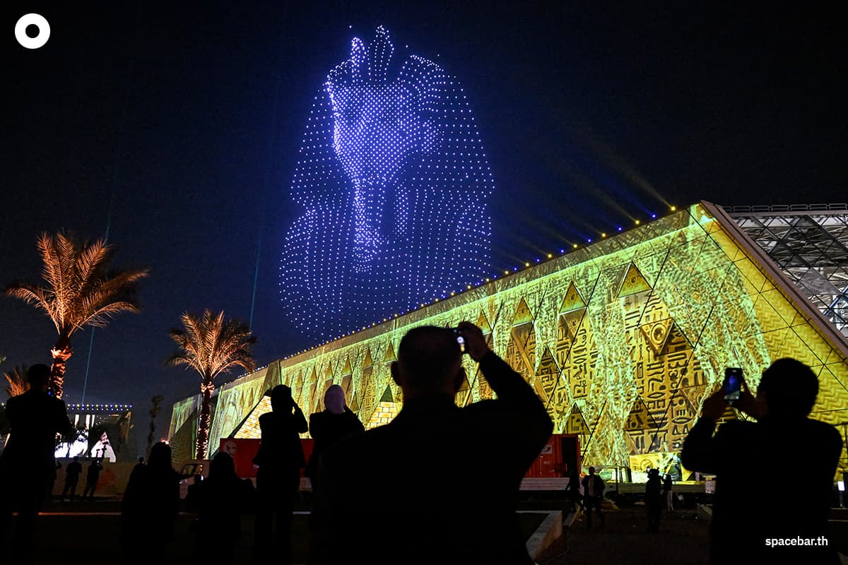 PhotoStory-เอฟเฟกต์แสงสีรูปหน้ากากพระศพของกษัตริย์ตุตันคาเมนแห่งอียิปต์โบราณส่องสว่างท้องฟ้าในพิธีเปิดพิพิธภัณฑ์ Grand Egyptian Museum ในเมืองกิซา ชานเมืองทางตะวันตกเฉียงใต้ของกรุงไคโร เมื่อวันที่ 1 พฤศจิกายน 2025 (Photo by Khaled DESOUKI / AFP)
