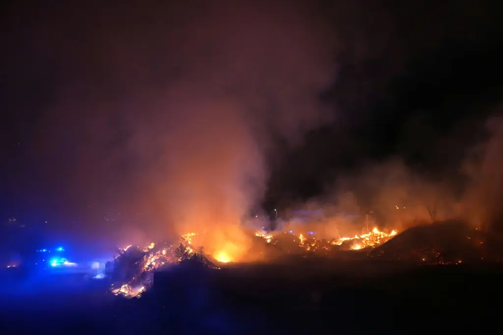 Two major blazes have merged near Madrid, with the smell of burning reaching the Spanish capital